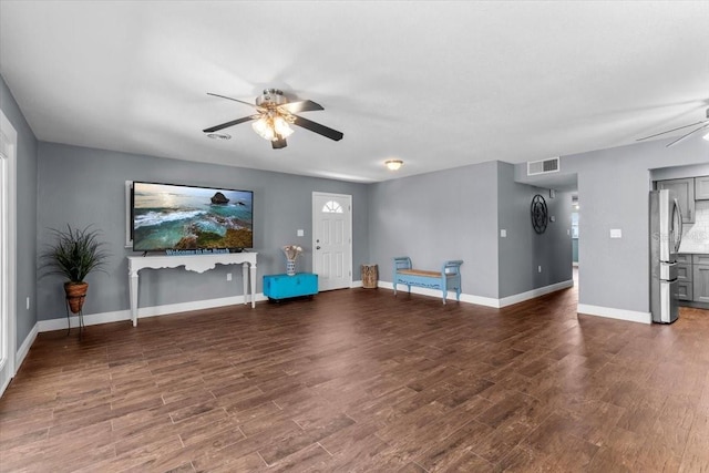 5051 Bonito Dr, New Port Richey, FL 34652 - unfurnished living room with a ceiling fan, wood finished floors, and baseboards