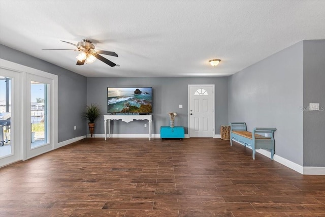 5051 Bonito Dr, New Port Richey, FL 34652 - unfurnished living room with a ceiling fan, wood finished floors, baseboards, and a textured ceiling