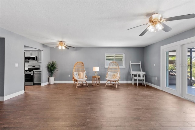 5051 Bonito Dr, New Port Richey, FL 34652 - sitting room with ceiling fan, dark wood-style floors, a textured ceiling, and baseboards
