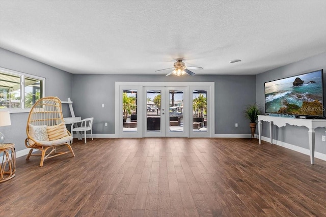 5051 Bonito Dr, New Port Richey, FL 34652 - living area with wood finished floors, a ceiling fan, baseboards, and a textured ceiling