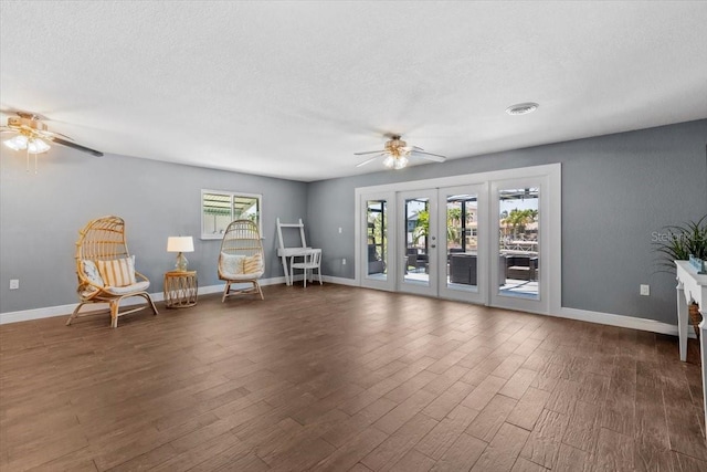 5051 Bonito Dr, New Port Richey, FL 34652 - living area featuring ceiling fan, wood finished floors, baseboards, a textured ceiling, and french doors