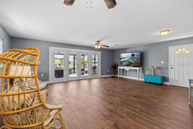5051 Bonito Dr, New Port Richey, FL 34652 - living area with a ceiling fan, wood finished floors, baseboards, and a textured ceiling