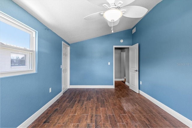 5051 Bonito Dr, New Port Richey, FL 34652 - empty room with lofted ceiling, ceiling fan, wood finished floors, and baseboards