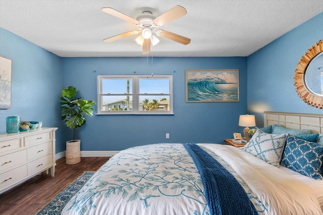 5051 Bonito Dr, New Port Richey, FL 34652 - bedroom with dark wood-style flooring, a textured ceiling, baseboards, and a ceiling fan