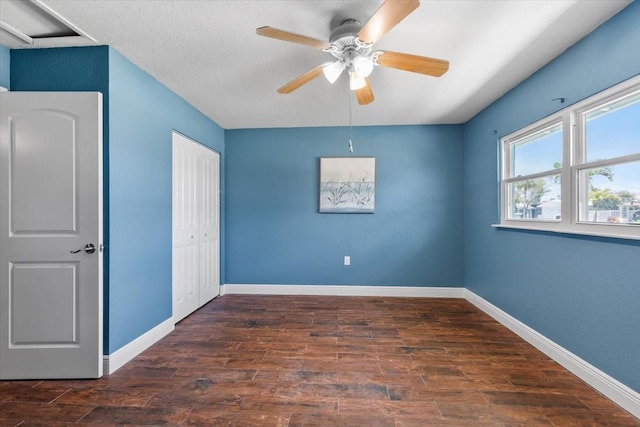 5051 Bonito Dr, New Port Richey, FL 34652 - unfurnished bedroom with wood finished floors, baseboards, a closet, and ceiling fan