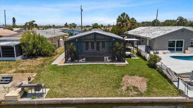 5051 Bonito Dr, New Port Richey, FL 34652 - back of house featuring a sunroom, a patio area, an outdoor pool, and a residential view