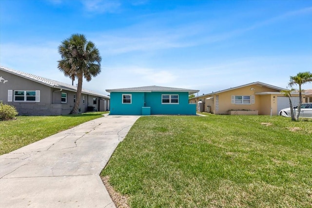 5051 Bonito Dr, New Port Richey, FL 34652 - ranch-style house with a front yard, concrete driveway, stucco siding, and cooling unit
