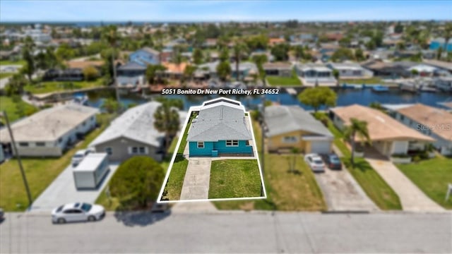 5051 Bonito Dr, New Port Richey, FL 34652 - aerial view of residential area with property boundaries highlighted and a large body of water