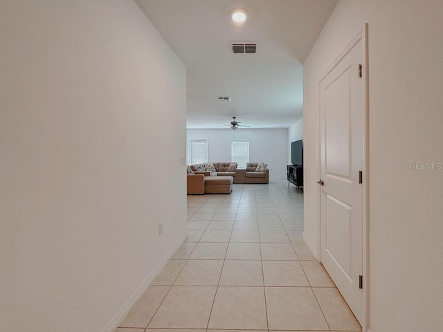 6444 Bar S Bar Trl, Zephyrhills, FL 33541 - corridor featuring light tile patterned flooring and baseboards