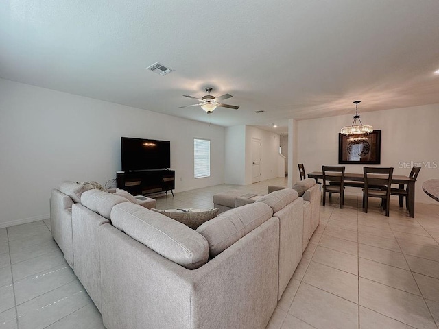 6444 Bar S Bar Trl, Zephyrhills, FL 33541 - living area featuring light tile patterned floors, a chandelier, a ceiling fan, and baseboards