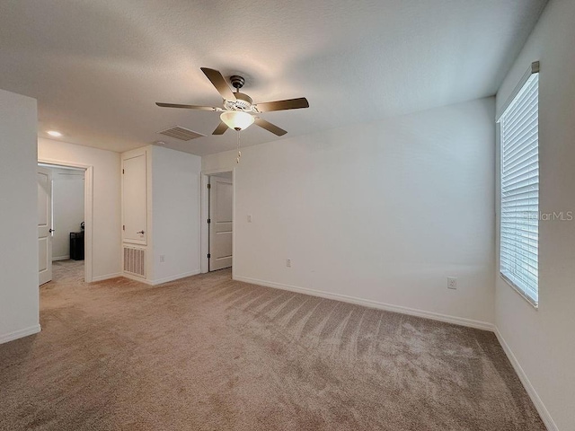 6444 Bar S Bar Trl, Zephyrhills, FL 33541 - unfurnished bedroom featuring light colored carpet, multiple windows, and baseboards