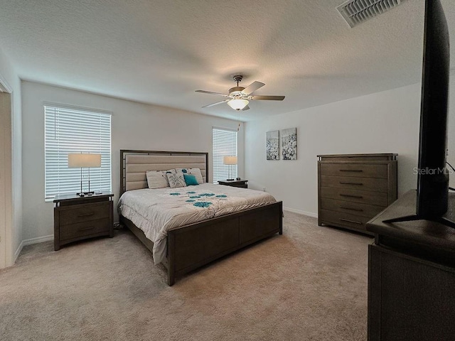 6444 Bar S Bar Trl, Zephyrhills, FL 33541 - bedroom featuring light carpet, baseboards, a ceiling fan, and a textured ceiling