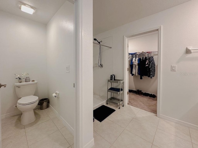 6444 Bar S Bar Trl, Zephyrhills, FL 33541 - full bathroom with a stall shower, tile patterned flooring, toilet, a spacious closet, and baseboards