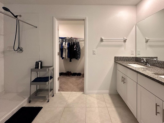 6444 Bar S Bar Trl, Zephyrhills, FL 33541 - bathroom with a stall shower, vanity, a spacious closet, tile patterned floors, and baseboards