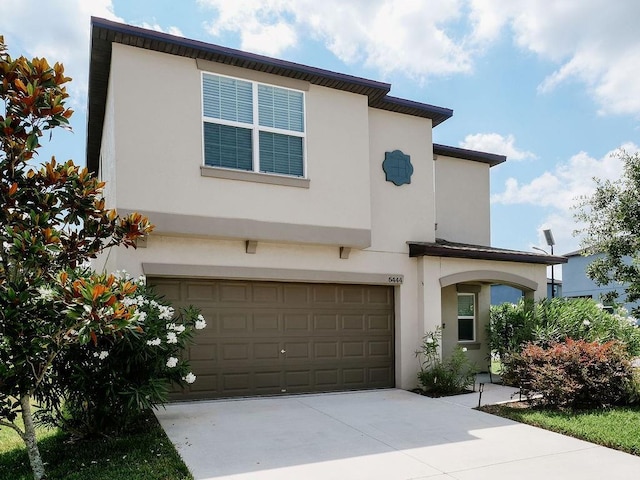 6444 Bar S Bar Trl, Zephyrhills, FL 33541 - view of front of property with an attached garage, stucco siding, and driveway