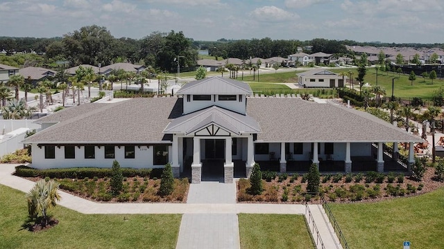 6444 Bar S Bar Trl, Zephyrhills, FL 33541 - view of front of home with a front lawn, a residential view, and a shingled roof