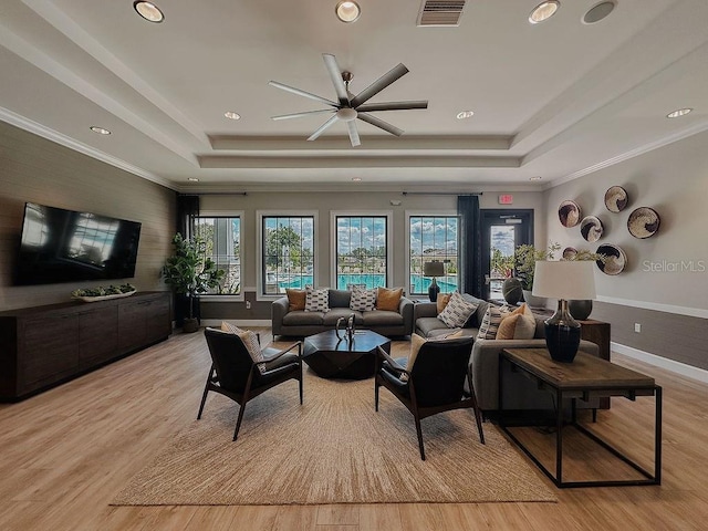 6444 Bar S Bar Trl, Zephyrhills, FL 33541 - living room featuring a raised ceiling, recessed lighting, light wood finished floors, ceiling fan, and ornamental molding