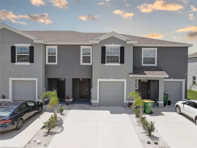 33062 Frosted Clover Way, Wesley Chapel, FL 33545 - townhome / multi-family property featuring driveway, stucco siding, a garage, and roof with shingles
