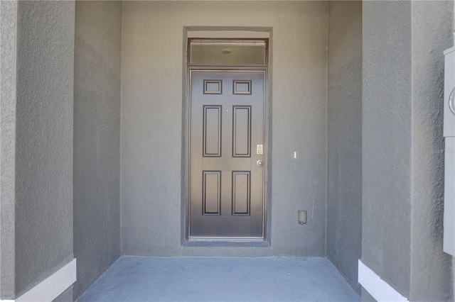 33062 Frosted Clover Way, Wesley Chapel, FL 33545 - doorway to property with stucco siding