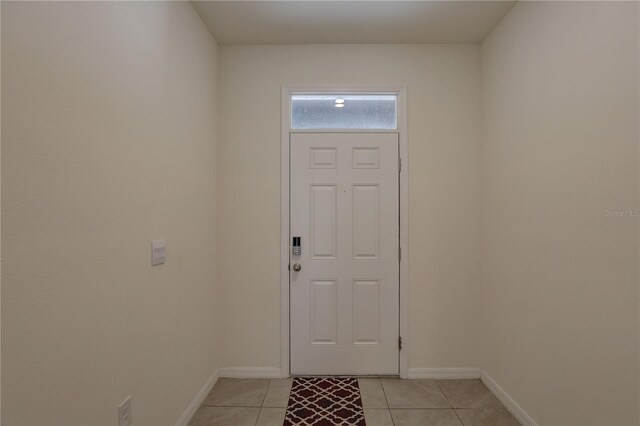 33062 Frosted Clover Way, Wesley Chapel, FL 33545 - doorway with baseboards and light tile patterned floors
