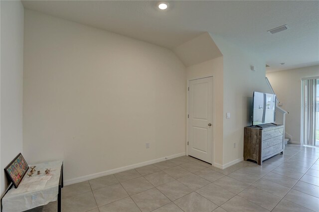 33062 Frosted Clover Way, Wesley Chapel, FL 33545 - unfurnished living room with light tile patterned floors, baseboards, and stairs