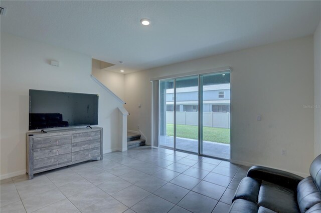 33062 Frosted Clover Way, Wesley Chapel, FL 33545 - living area featuring stairway, light tile patterned flooring, baseboards, and recessed lighting