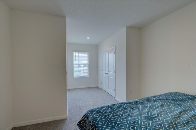 33062 Frosted Clover Way, Wesley Chapel, FL 33545 - bedroom featuring carpet flooring, baseboards, a closet, and recessed lighting