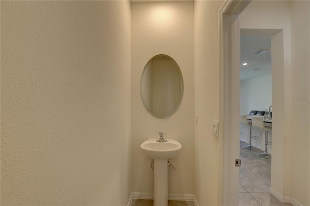 33062 Frosted Clover Way, Wesley Chapel, FL 33545 - bathroom featuring tile patterned floors, baseboards, and a sink