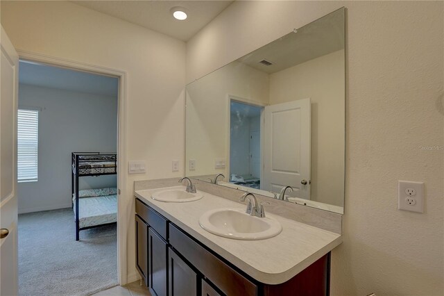 33062 Frosted Clover Way, Wesley Chapel, FL 33545 - bathroom with ensuite bath, double vanity, and baseboards