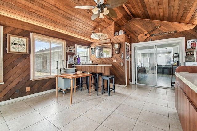509 Stone Dr, Brandon, FL 33510 - dining space with wood walls, wooden ceiling, vaulted ceiling, a ceiling fan, and light tile patterned flooring