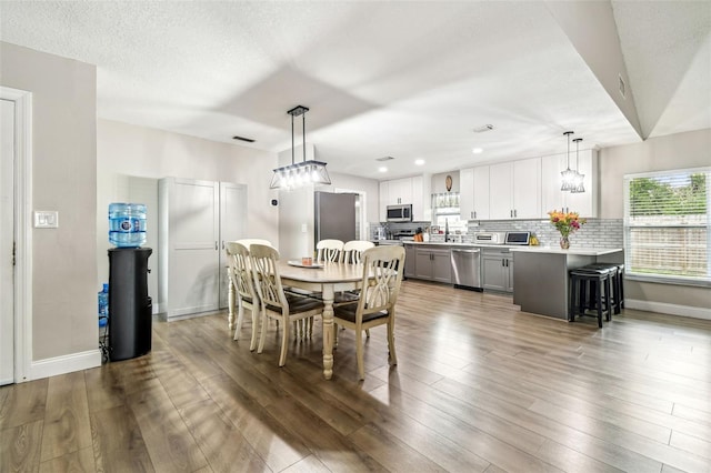 509 Stone Dr, Brandon, FL 33510 - dining space featuring wood finished floors, baseboards, and recessed lighting