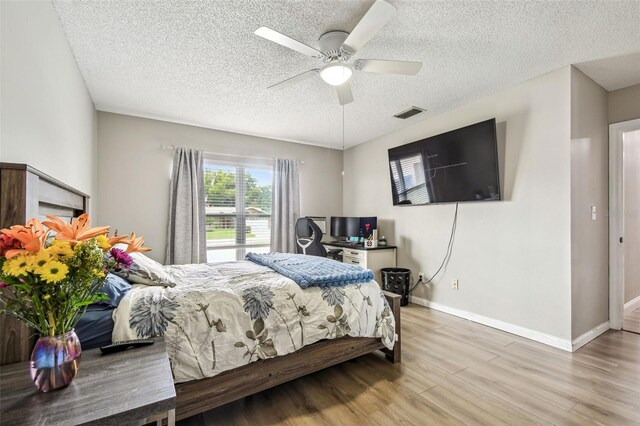 509 Stone Dr, Brandon, FL 33510 - bedroom with wood finished floors, a textured ceiling, baseboards, and ceiling fan