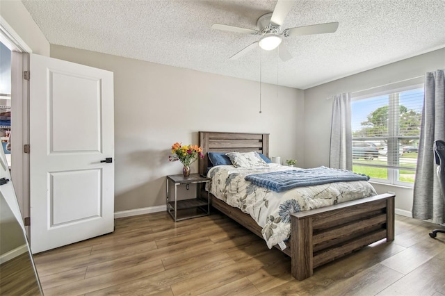 509 Stone Dr, Brandon, FL 33510 - bedroom with a textured ceiling, wood finished floors, ceiling fan, and baseboards