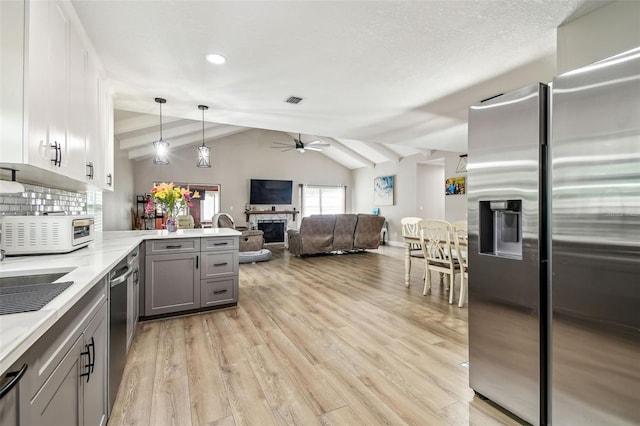 509 Stone Dr, Brandon, FL 33510 - kitchen featuring stainless steel appliances, a ceiling fan, gray cabinets, a peninsula, and light wood-style floors