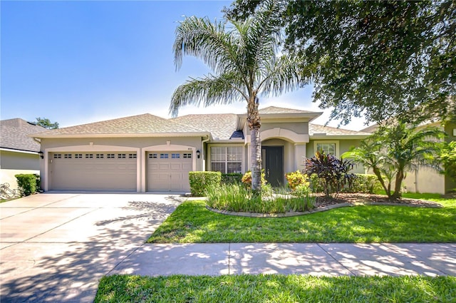 445 Arch Ridge Loop, Seffner, FL 33584 - view of front of house featuring stucco siding, an attached garage, concrete driveway, and a front yard