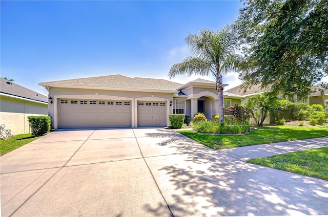 445 Arch Ridge Loop, Seffner, FL 33584 - view of front of house featuring concrete driveway, an attached garage, and stucco siding
