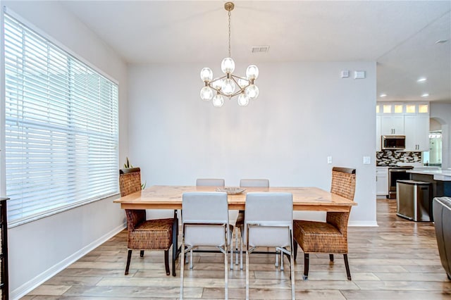 445 Arch Ridge Loop, Seffner, FL 33584 - dining space featuring a chandelier, light wood-style floors, recessed lighting, baseboards, and arched walkways