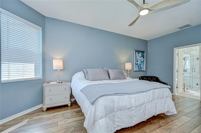 445 Arch Ridge Loop, Seffner, FL 33584 - bedroom featuring wood-type flooring, baseboards, ceiling fan, and ensuite bathroom