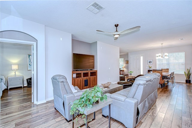 445 Arch Ridge Loop, Seffner, FL 33584 - living area featuring light wood-type flooring, a chandelier, ceiling fan, and plenty of natural light