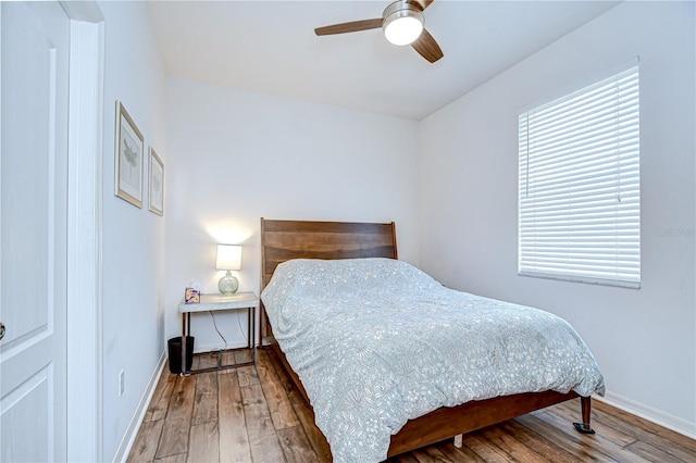 445 Arch Ridge Loop, Seffner, FL 33584 - bedroom with wood finished floors, baseboards, and a ceiling fan