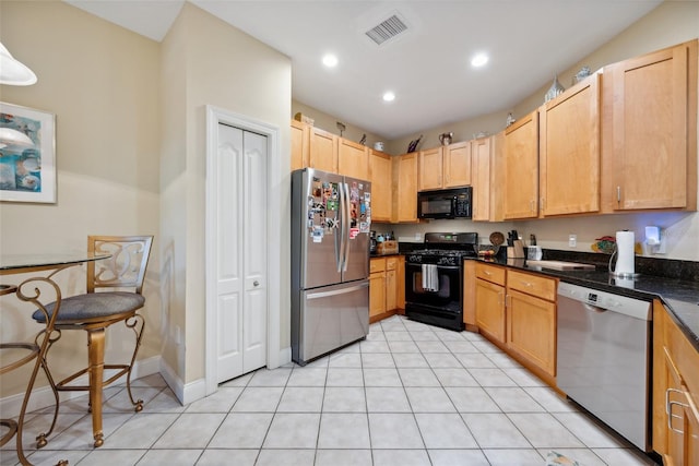 7246 Gaberia Rd, New Port Richey, FL 34655 - kitchen with black appliances, recessed lighting, light tile patterned flooring, light brown cabinets, and baseboards