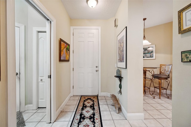 7246 Gaberia Rd, New Port Richey, FL 34655 - foyer entrance with baseboards and light tile patterned floors
