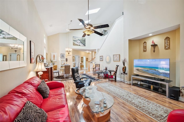 7246 Gaberia Rd, New Port Richey, FL 34655 - living area with a chandelier, wood finished floors, high vaulted ceiling, ceiling fan, and a skylight
