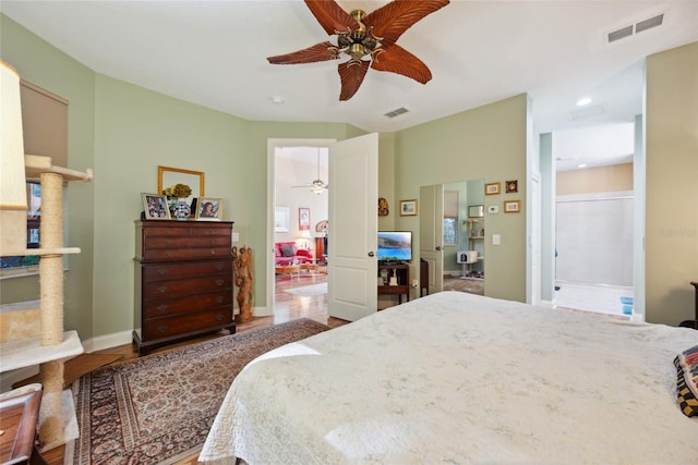 7246 Gaberia Rd, New Port Richey, FL 34655 - bedroom featuring baseboards, wood finished floors, recessed lighting, ceiling fan, and connected bathroom