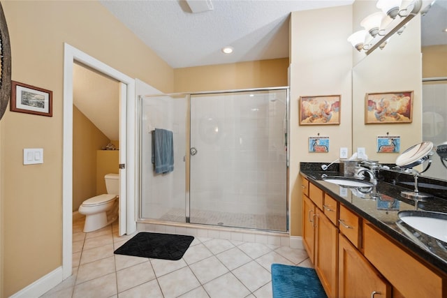 7246 Gaberia Rd, New Port Richey, FL 34655 - bathroom with toilet, a shower stall, double vanity, tile patterned floors, and a textured ceiling