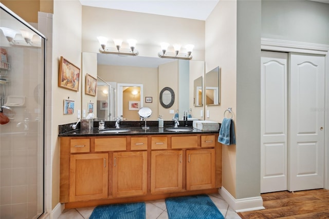 7246 Gaberia Rd, New Port Richey, FL 34655 - full bathroom with a stall shower, double vanity, and tile patterned flooring