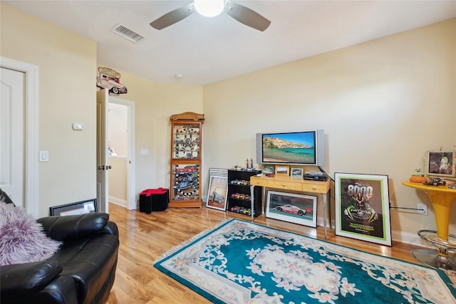 7246 Gaberia Rd, New Port Richey, FL 34655 - living area with a ceiling fan, wood finished floors, and baseboards