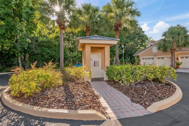 7246 Gaberia Rd, New Port Richey, FL 34655 - view of exterior entry with stucco siding and a garage
