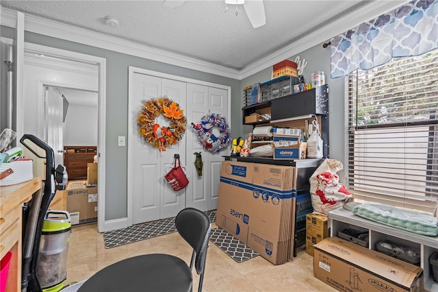 office space with crown molding, a ceiling fan, a textured ceiling, and light tile patterned floors