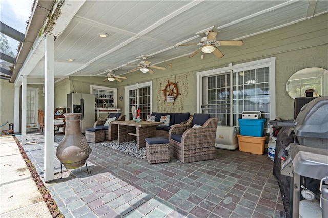 view of patio / terrace featuring ceiling fan and an outdoor living space